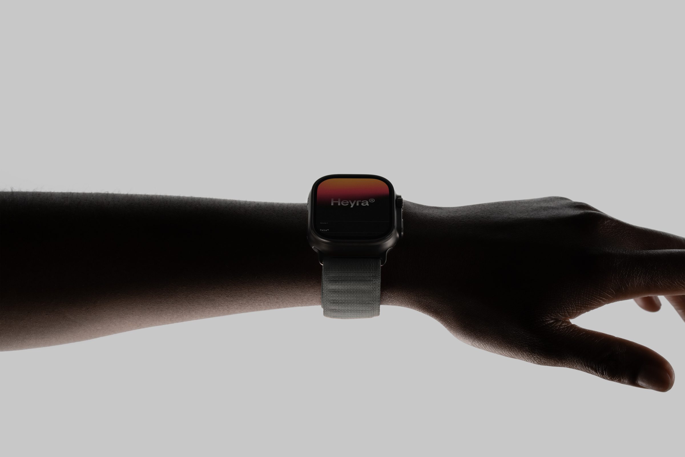 Heyra's voice agent on a watch, on a wrist held out against a grey backdrop.